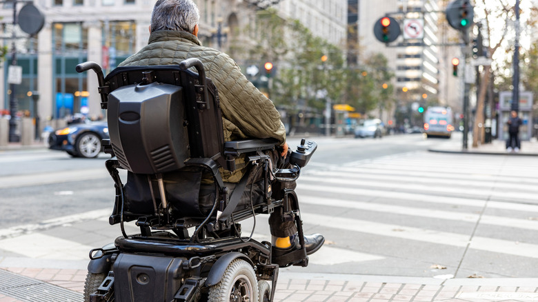 Person riding in motorized wheelchair