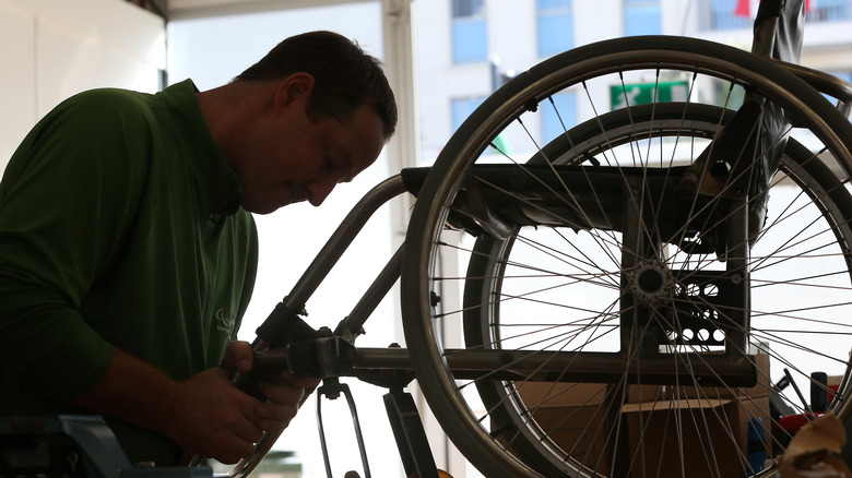 Technician repairing a wheelchair