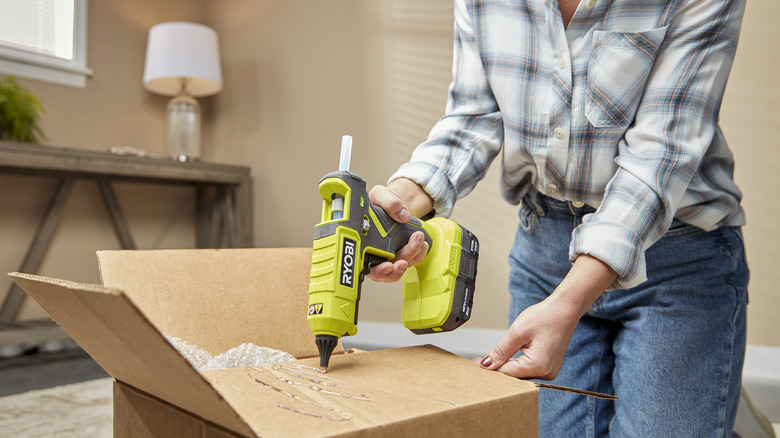 Person using Ryobi dual-temp glue gun