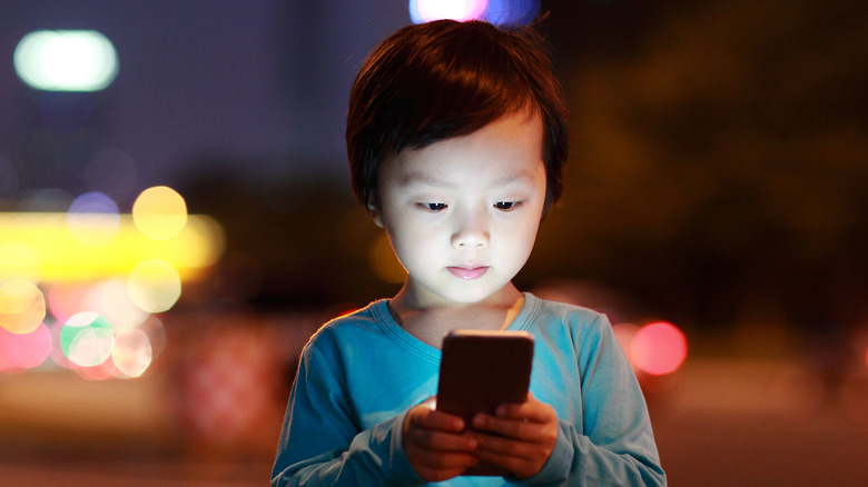 Little girl looking at phone screen