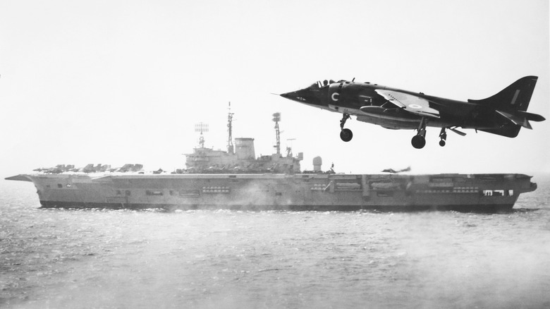 Harrier jet with HMS Ark Royal in background