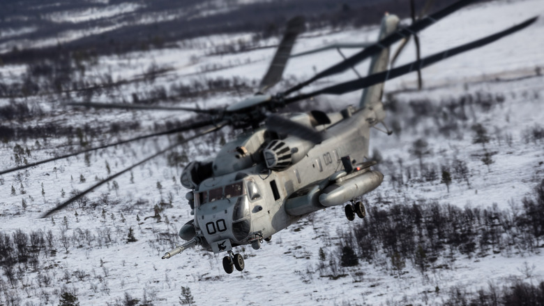 Super Stallion flies above snowy ground