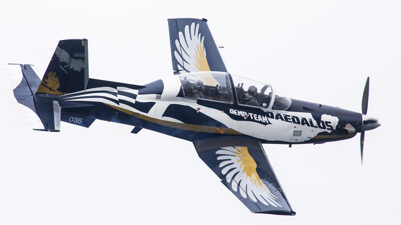 A Greek T-6 Texan II flying over cloudy skies at the Thessaloniki air show in 2024