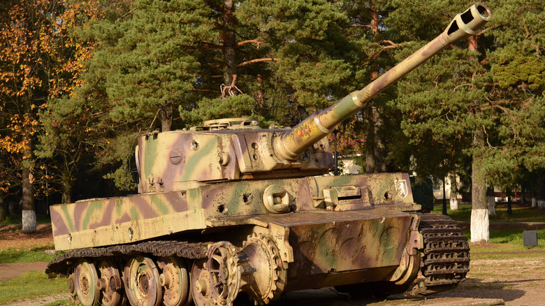 A wrecked Tiger tank sitting in a field.