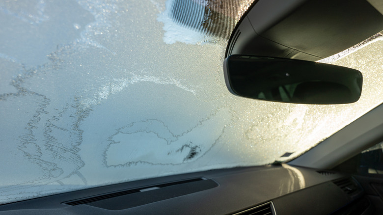 Frosted windshield from the inside of a car.