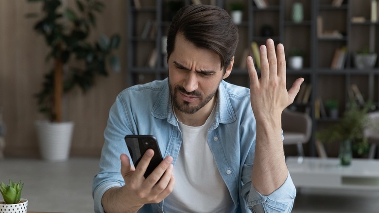 Man frustrated with smartphone