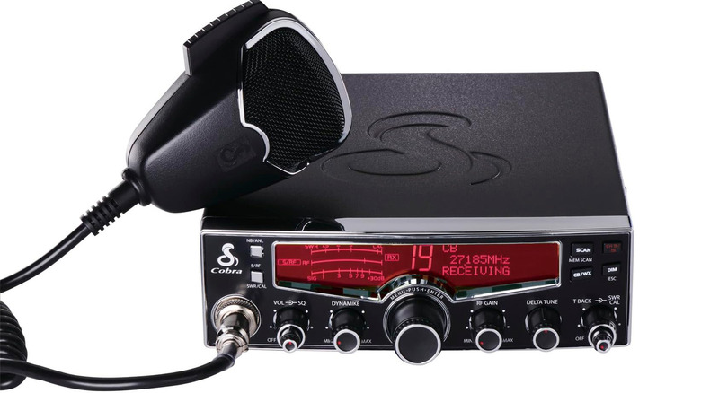 CB radio with microphone on plain background