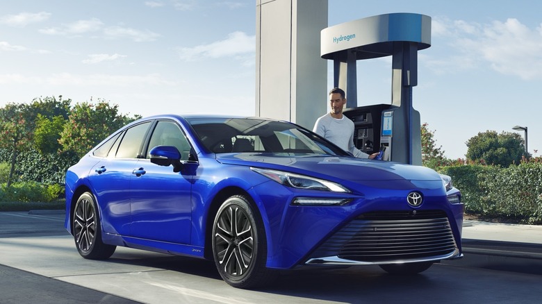 Front 3/4 view of Toyota Mirai at hydrogen fuel station