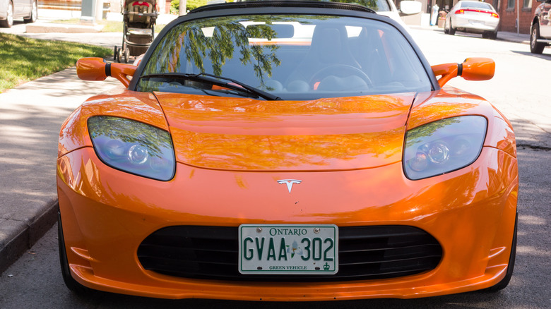 A Tesla Roadster parked