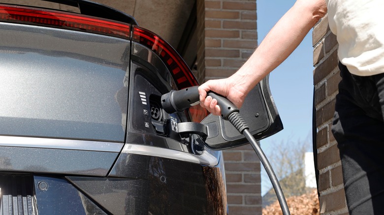 man using an ev charger