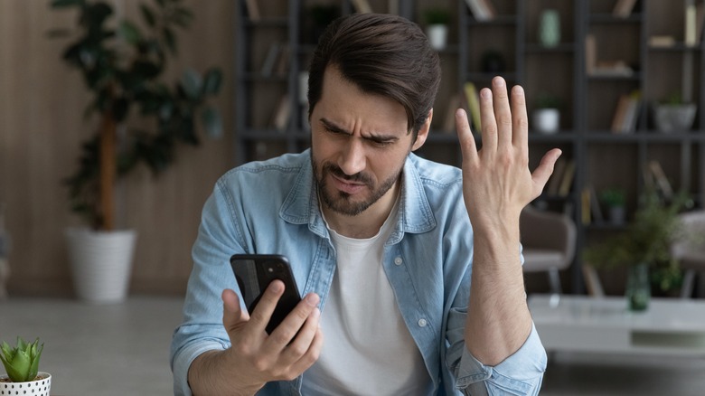 Man frustrated with smartphone