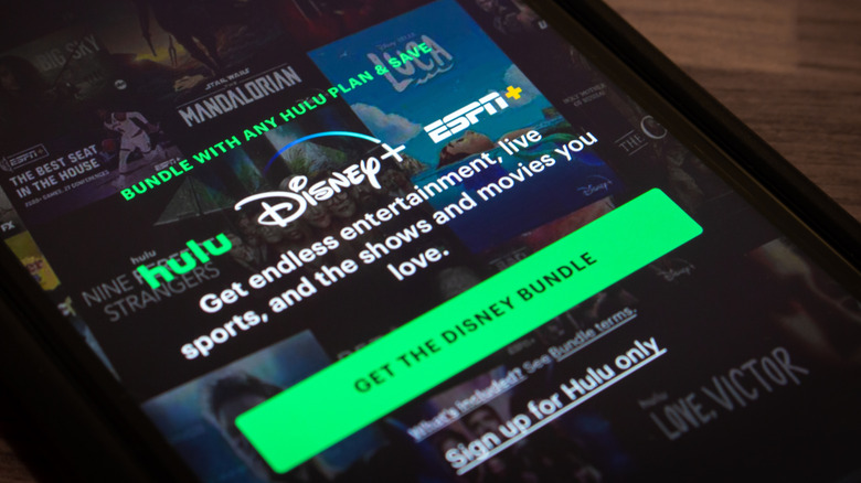 Smartphone with advertisement for Hulu Disney+ ESPN+ Bundle