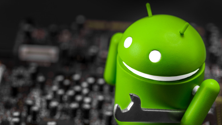 Android figure holding a spanner