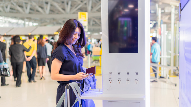 Person standing at airport charging station