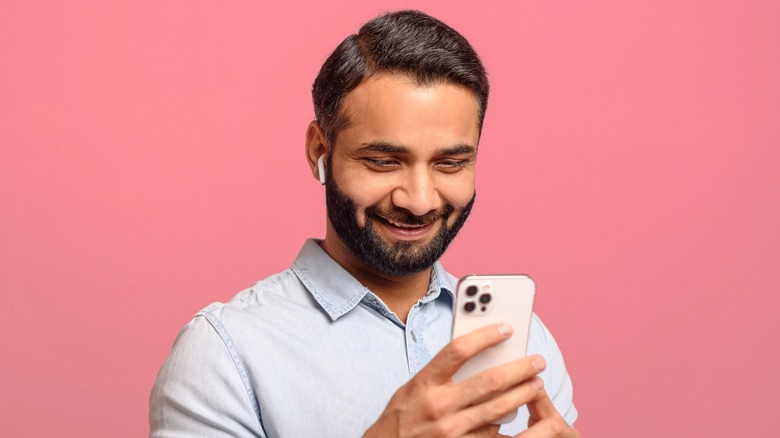 guy using AirPods and iPhone