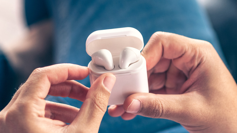 AirPods charging case hands