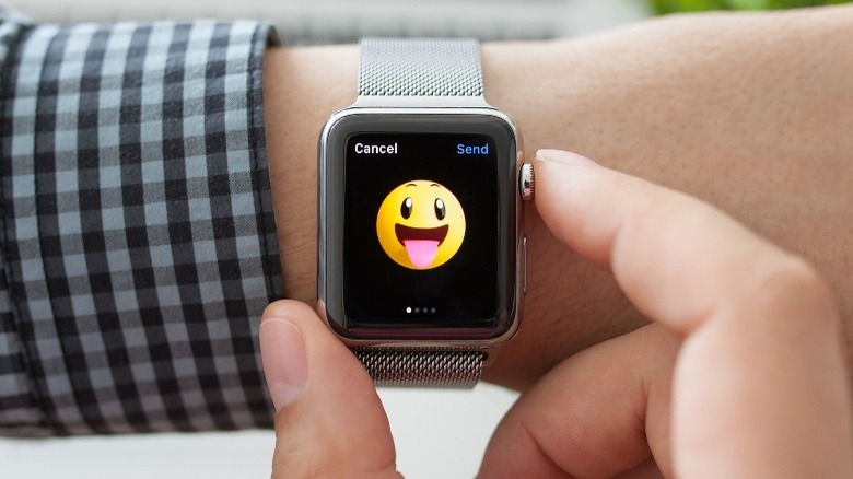 Apple Watch with a smiley on the screen