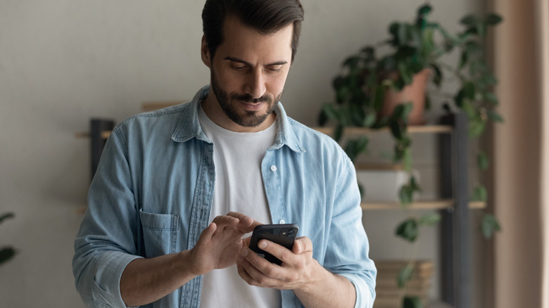 man pressing iphone