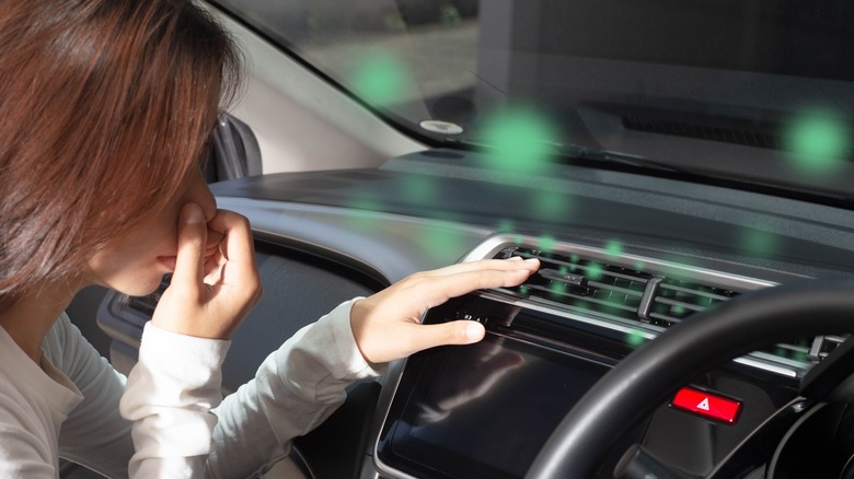 Woman holding noise and checking A/C