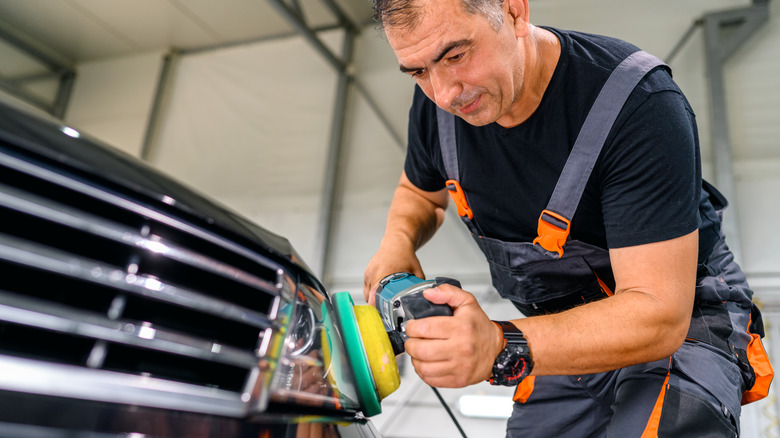 man polishing headlights