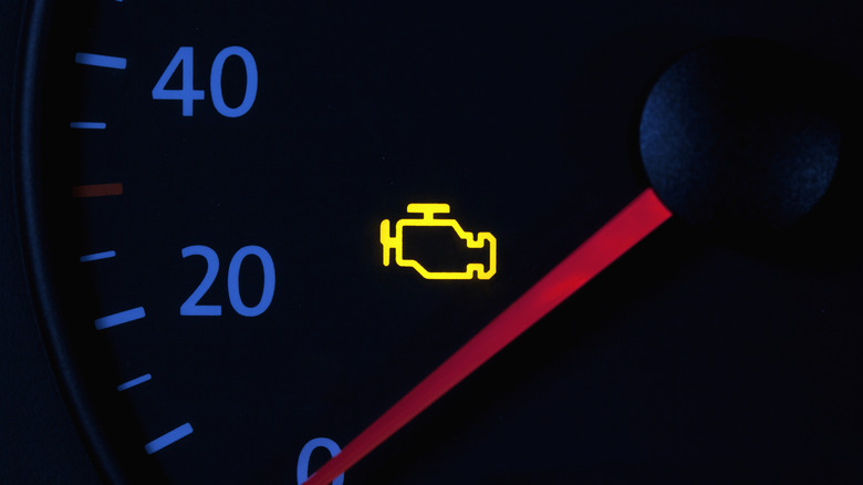 yellow engine check engine icon on car dashboard