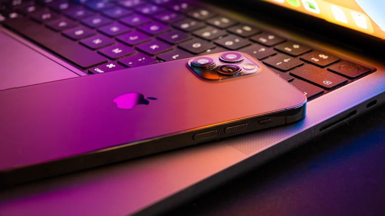 iPhone laying on top of MacBook keyboard