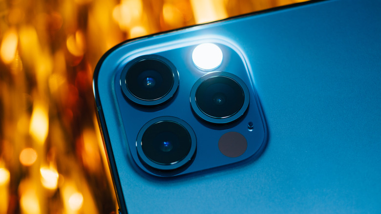 iPhone 14 Pro cameras with the flashlight lit up