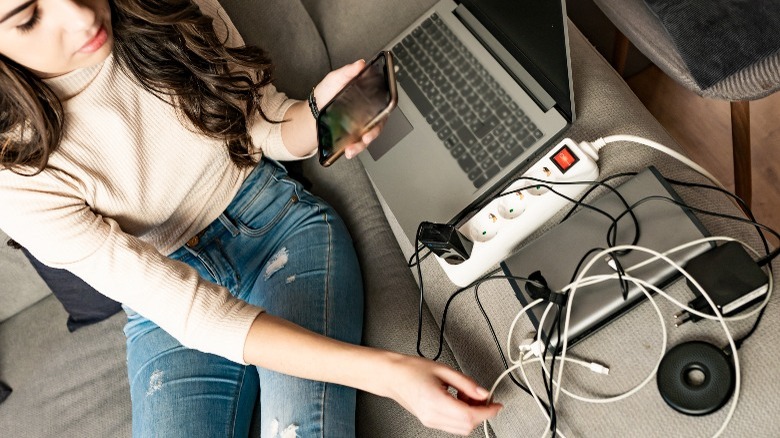 Woman charging phone with multiple options