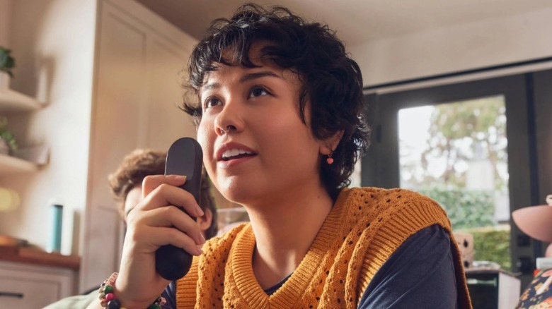 Person holding TV remote