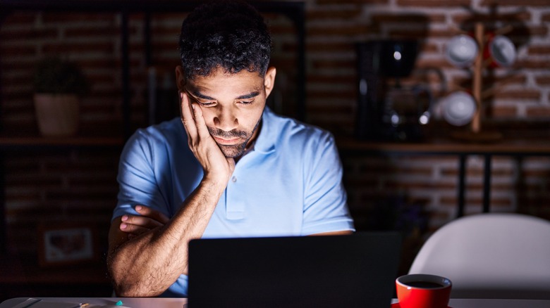 person looking at laptop at night