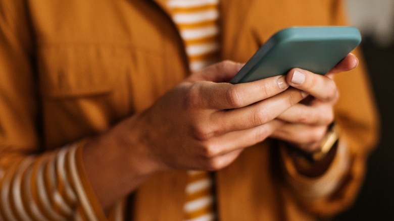  unrecognizable woman using a mobile phone indoors