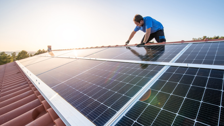 Man installing solar panels