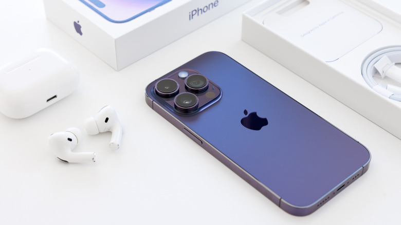 Apple iPhone and AirPods placed next to each other.