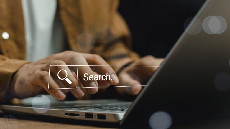 Man using search bar on laptop