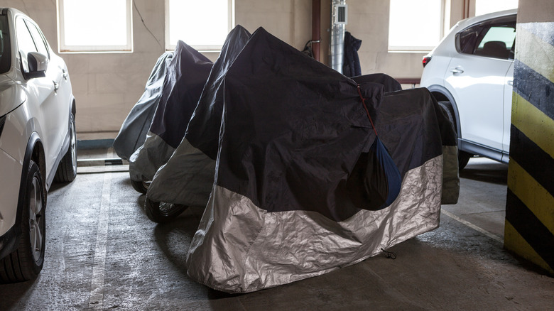 Covered motorcycles in garage