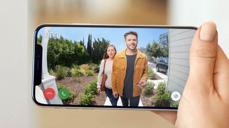 hand holding smartphone with Ring app