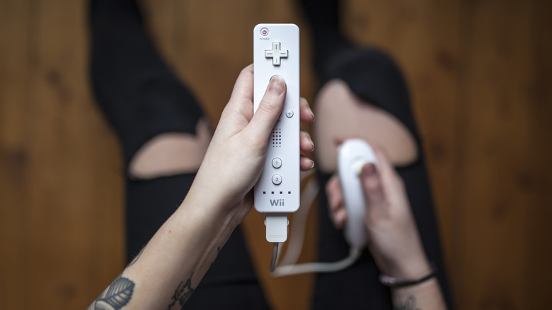 Man using Wii Remote and nunchuck