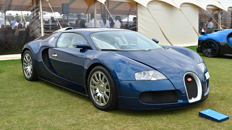 An all-blue Bugatti Veyron at an open air auto show, front 3/4 view