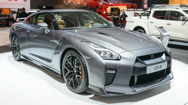 A gray Nissan GT-R at an auto show, front 3/4 view