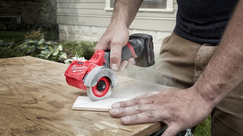 DIYer cutting wood with Cut Off Tool