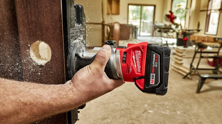 woodworker using M18 router