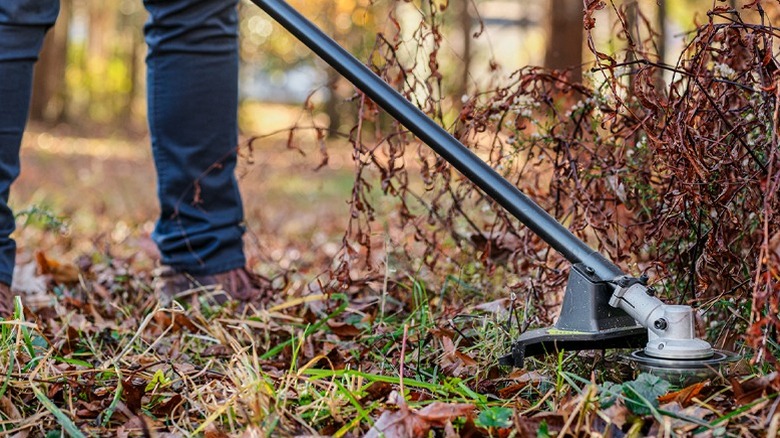 The 18V ONE+ HP Brushless Brush Cutter/String Trimmer in use.