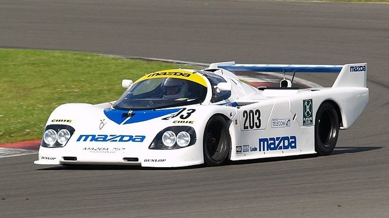 White and blue Mazda 757 on racetrack