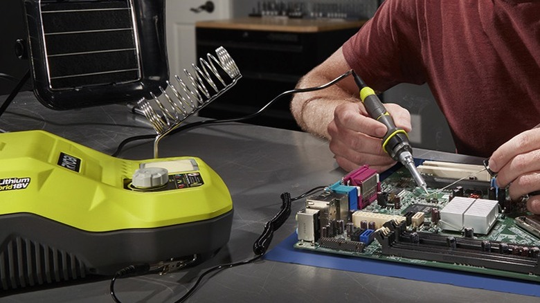 Man using a 18V ONE+ 45W Hybrid Soldering Station