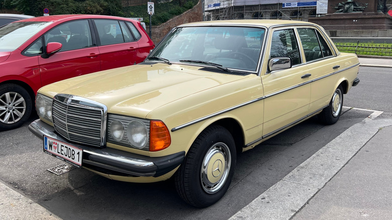 A W123 Mercedes, front 3/4 view, cream exterior