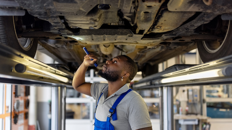 mechanic inspecting car