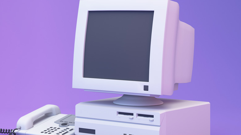 A render of an older PC and phone in front of a purple/pink background