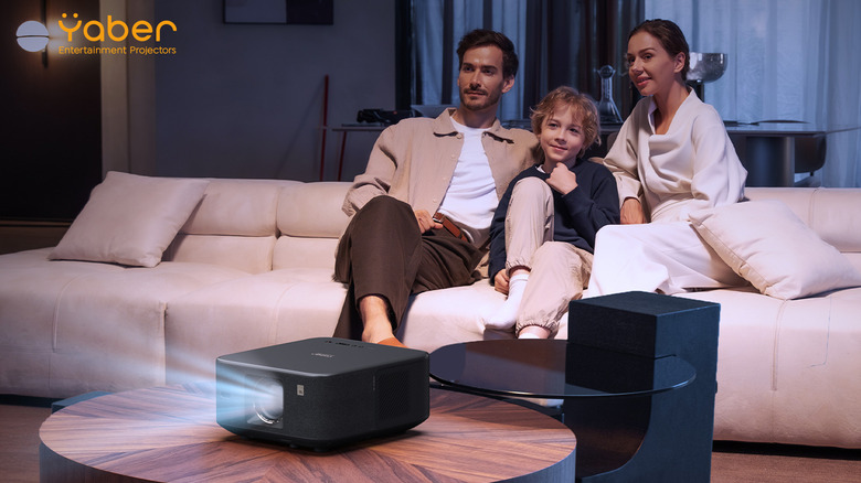 Family members on sofa enjoying their Yaber projector