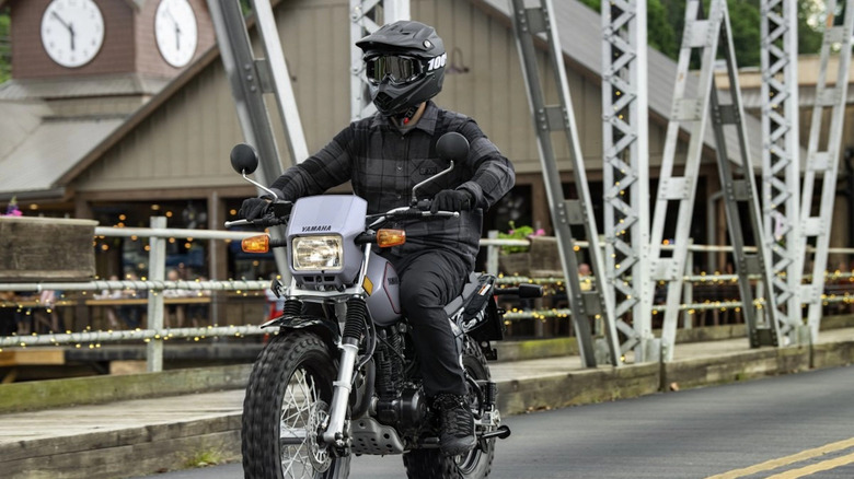 Person riding Yamaha TW200 in city