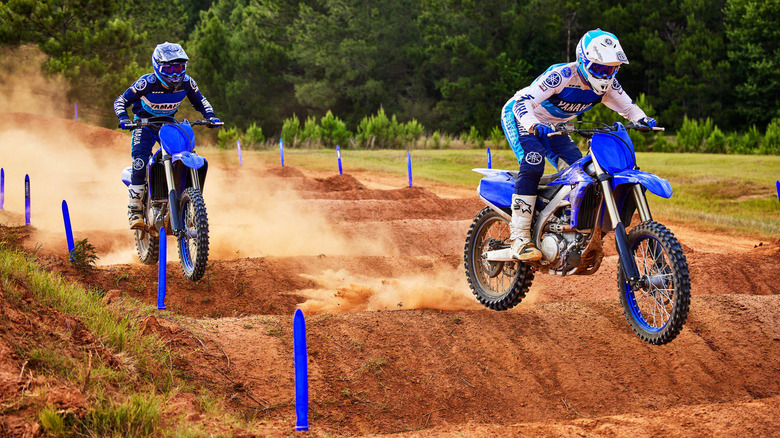 people riding blue offroad motorcycles 